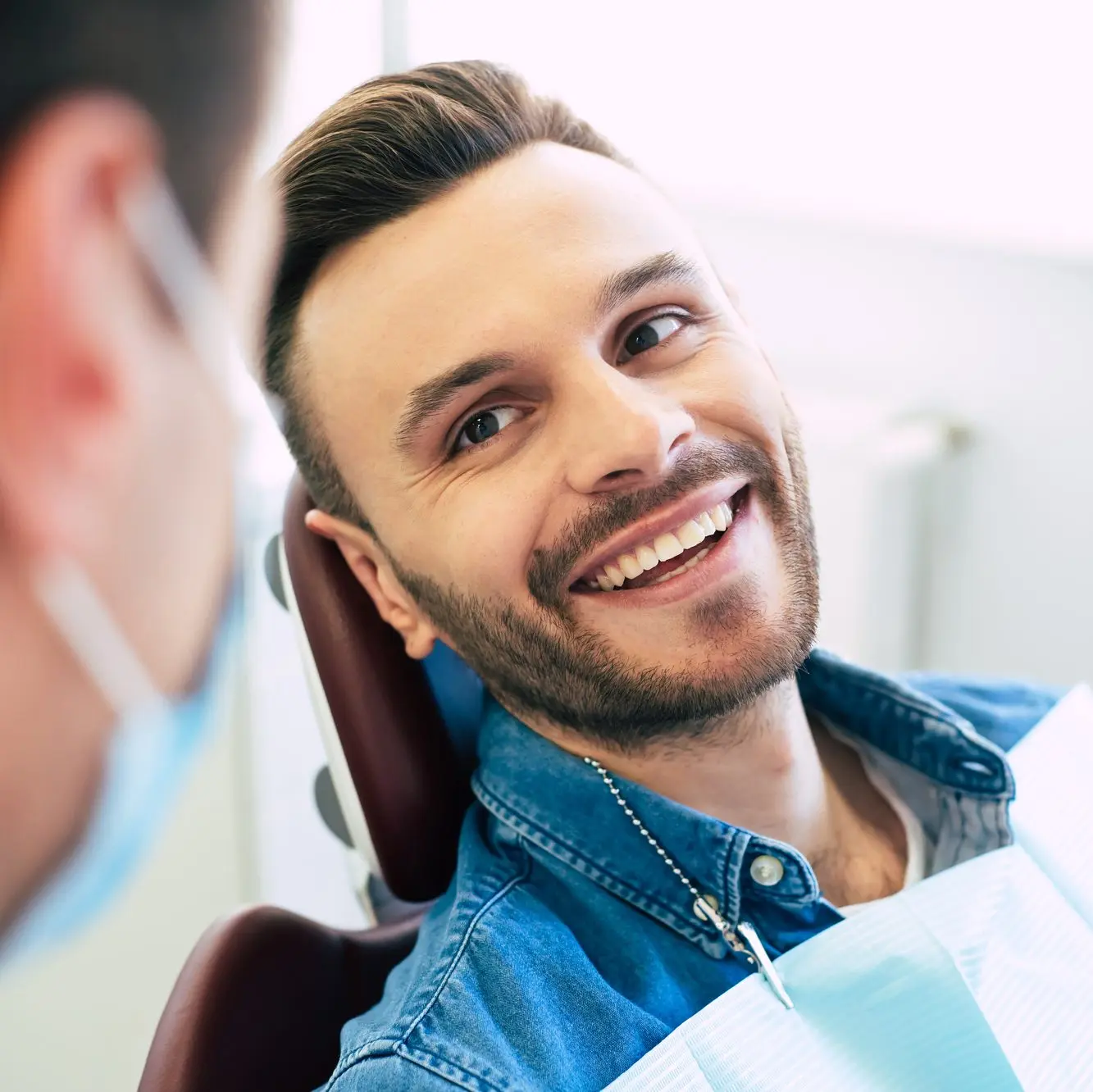 Patient smiling during a dental implant consultation at The Dental Center of Jefferson