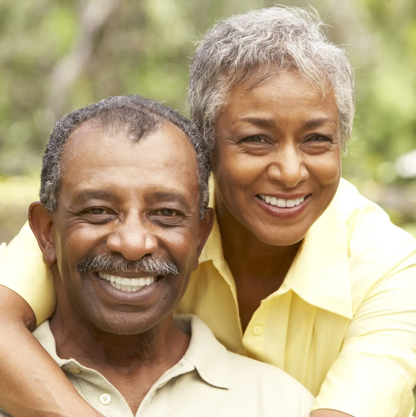 Happy senior couple smiling with confidence after dental implants